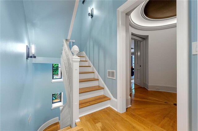 stairs with hardwood / wood-style flooring