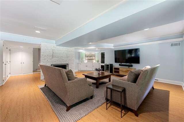 living room featuring light hardwood / wood-style floors and a fireplace