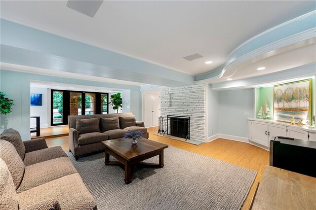 living room featuring light hardwood / wood-style floors and a fireplace