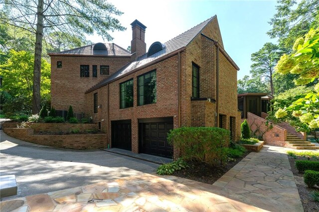 view of side of home featuring a garage