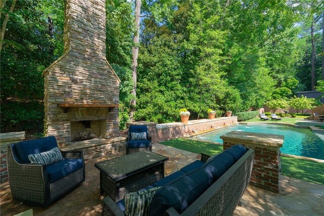 view of patio / terrace featuring an outdoor living space with a fireplace