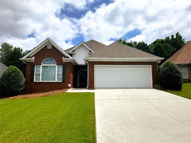 114 Vinings Way SE, Calhoun, GA 30701 - view of front facade featuring a garage, a front lawn, driveway, and brick siding