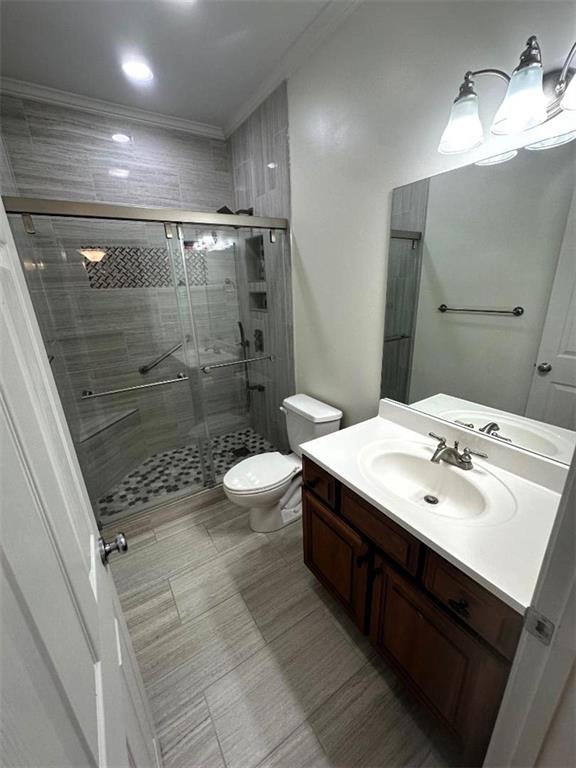 114 Vinings Way SE, Calhoun, GA 30701 - bathroom featuring vanity, a stall shower, toilet, and crown molding