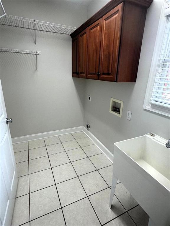 114 Vinings Way SE, Calhoun, GA 30701 - laundry area with hookup for a washing machine, hookup for an electric dryer, light tile patterned flooring, and cabinet space