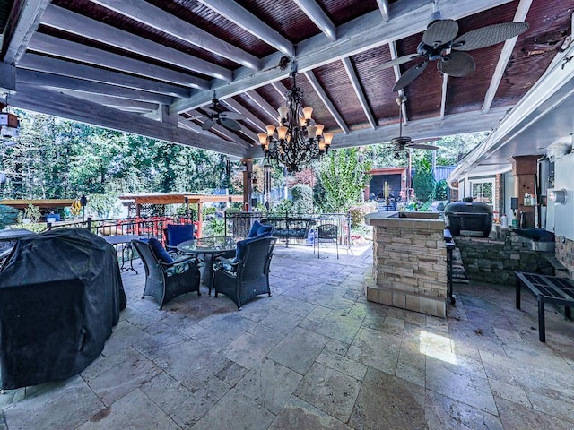 view of patio / terrace with an outdoor bar, ceiling fan, and a grill