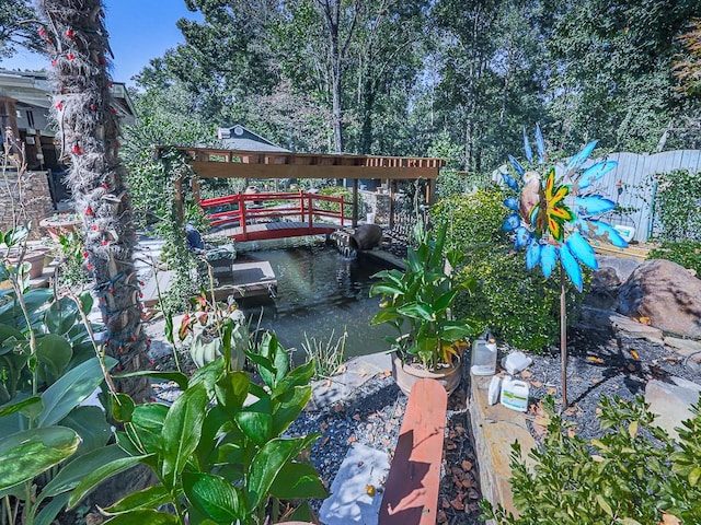 view of patio featuring a garden pond