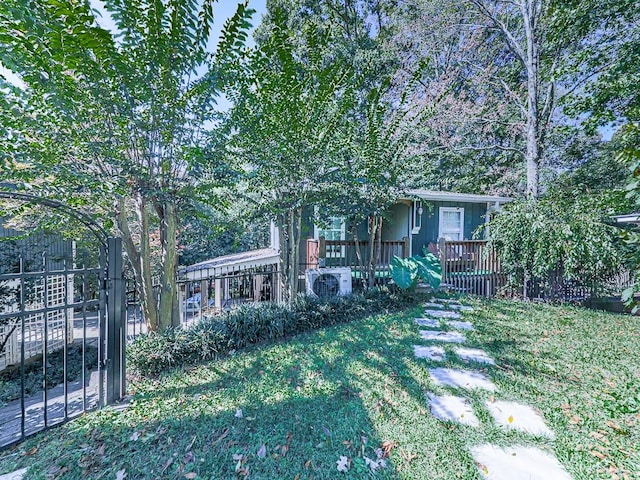 view of front of property featuring a front yard and ac unit