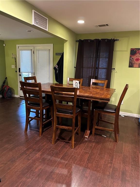 dining space featuring dark wood-type flooring