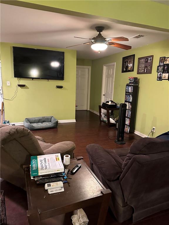 living room with ceiling fan and dark hardwood / wood-style floors