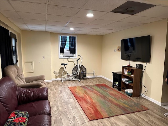 living room with a drop ceiling and hardwood / wood-style floors