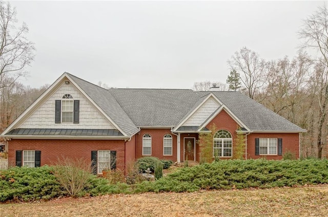 view of front of house featuring brick siding and a chimney