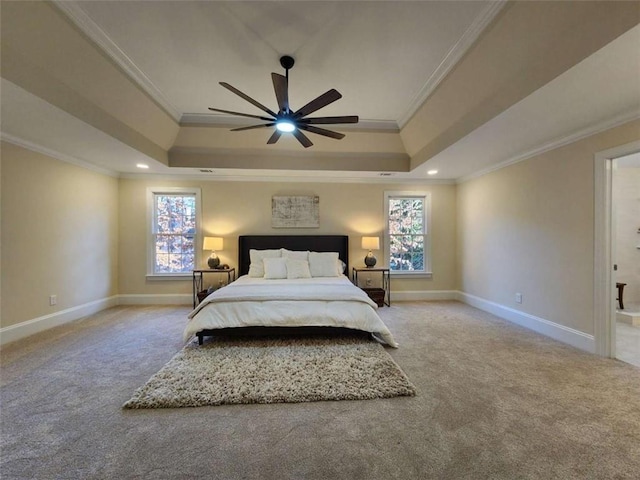 carpeted bedroom featuring a raised ceiling, ornamental molding, and multiple windows