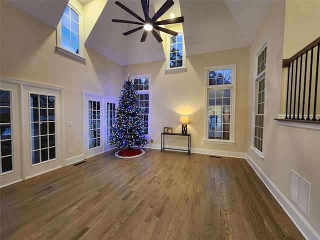 unfurnished room featuring ceiling fan, high vaulted ceiling, and hardwood / wood-style floors