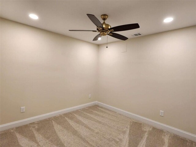 empty room featuring ceiling fan and carpet floors