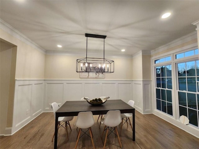 dining space with ornamental molding and dark hardwood / wood-style floors