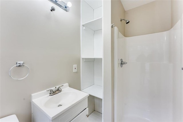 bathroom with walk in shower and vanity