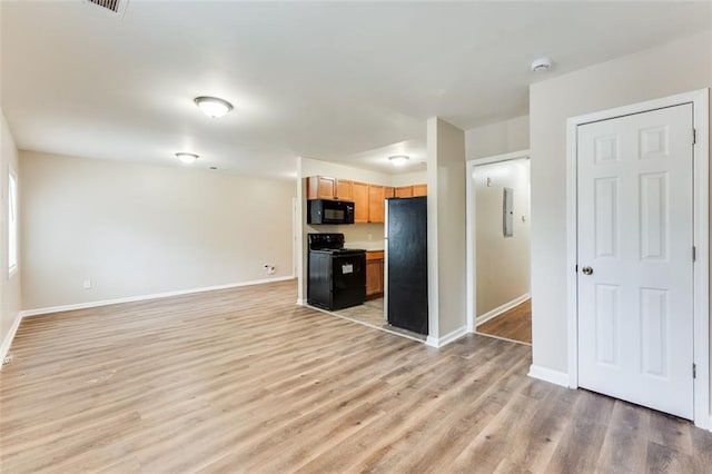 kitchen with black appliances and light wood-type flooring