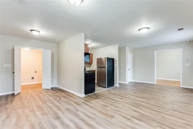 unfurnished living room with light hardwood / wood-style floors