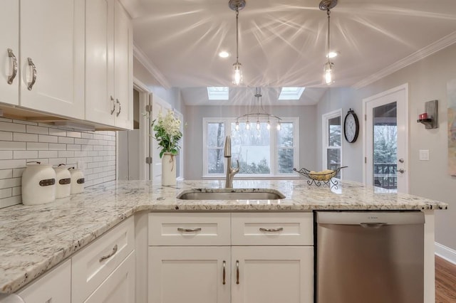 kitchen featuring sink, a skylight, white cabinets, and dishwasher