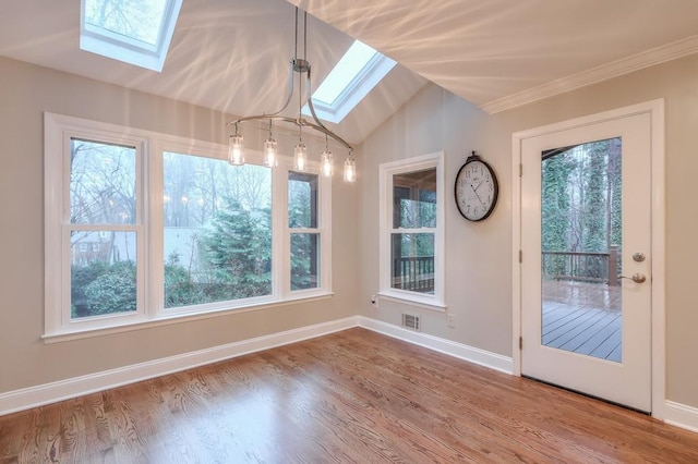 interior space featuring lofted ceiling with skylight