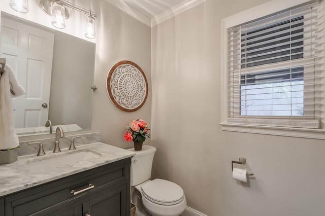 bathroom with ornamental molding, vanity, and toilet