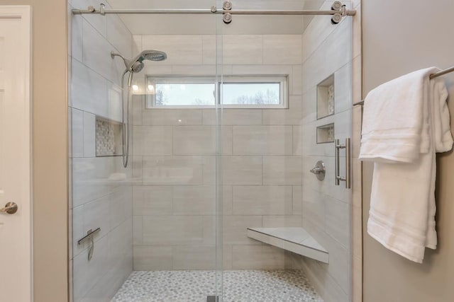 bathroom with a shower with shower door