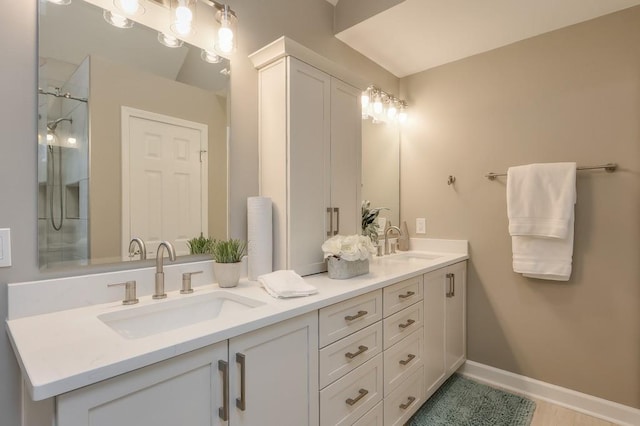 bathroom with vanity and a shower with door