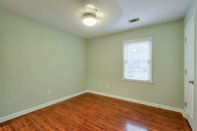 unfurnished room featuring ceiling fan and dark hardwood / wood-style flooring