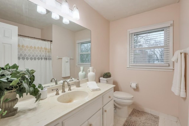 bathroom with vanity, toilet, and tile patterned flooring