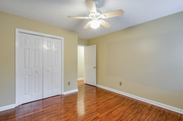 unfurnished bedroom featuring ceiling fan, hardwood / wood-style floors, and a closet