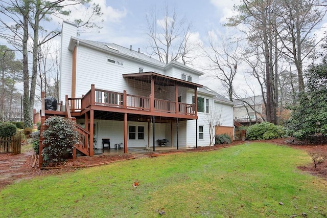 rear view of property with a yard and a deck