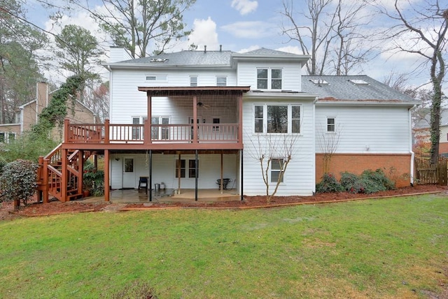 back of property with a patio, a yard, and a deck