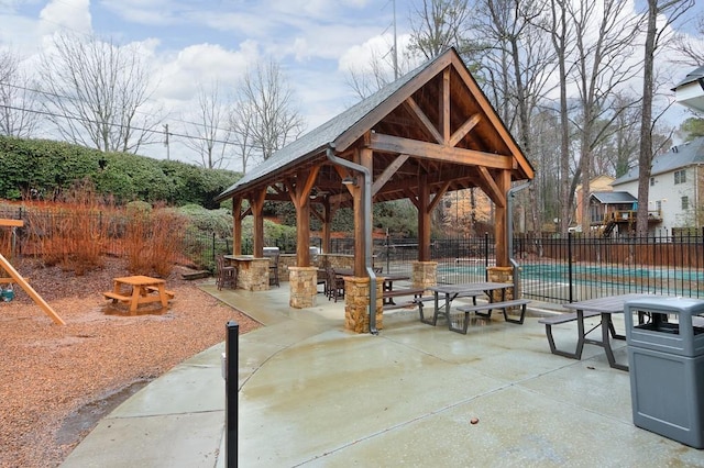 view of home's community with a gazebo, a swimming pool, exterior bar, and a patio