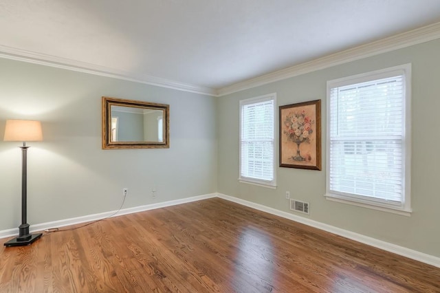 spare room with wood-type flooring and ornamental molding