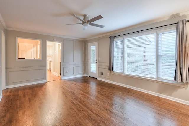 interior space featuring hardwood / wood-style flooring, ornamental molding, and ceiling fan