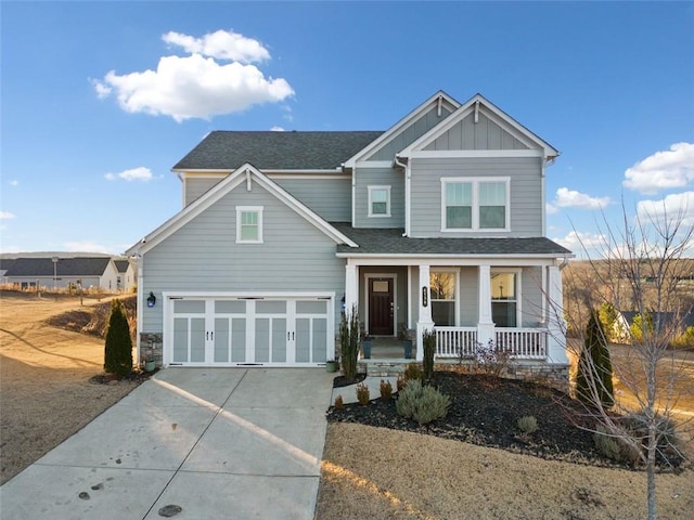 view of front of home featuring a porch and a garage