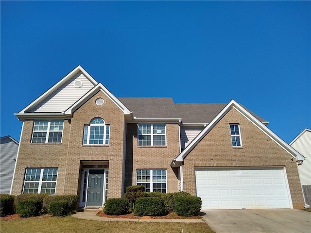 view of front of house with driveway and brick siding