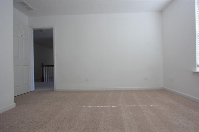 carpeted empty room featuring a ceiling fan, a textured ceiling, and baseboards