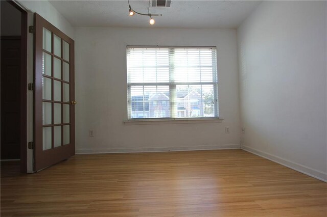 carpeted empty room with visible vents and baseboards