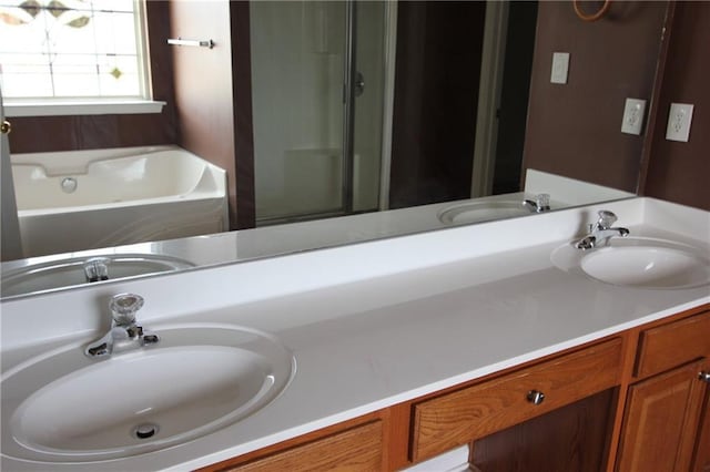 bathroom with a tub to relax in and vanity