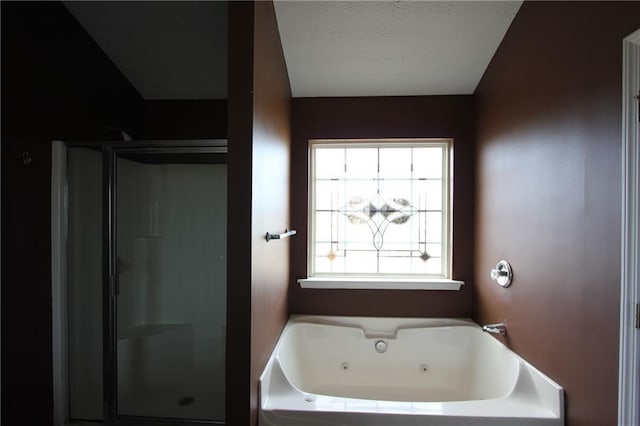 full bathroom featuring a jetted tub and a stall shower