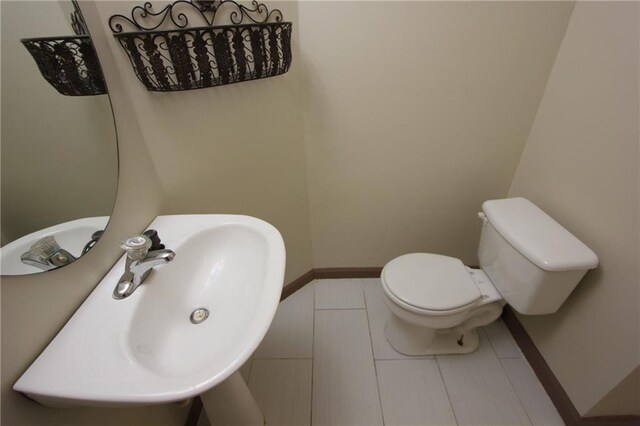 bathroom with vaulted ceiling, double vanity, and a sink