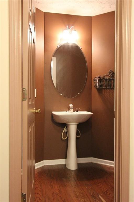 bathroom featuring baseboards and wood finished floors