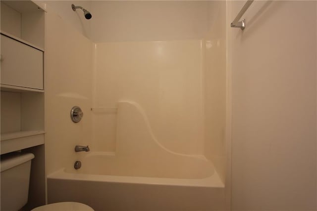 bathroom featuring shower / bath combination and toilet