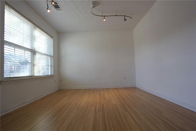 carpeted spare room with baseboards and a notable chandelier