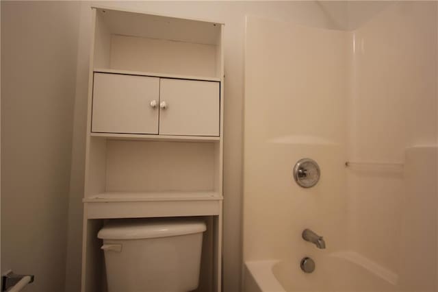 bathroom featuring bathtub / shower combination and toilet