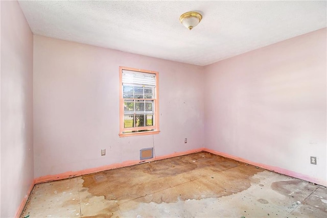 spare room with baseboards