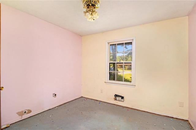 empty room with concrete floors and baseboards