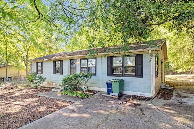 ranch-style home with fence