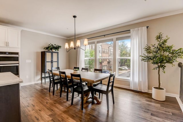 dining space featuring plenty of natural light, dark wood-type flooring, and a notable chandelier